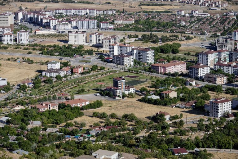 Aerial cityscape of Elâzığ, Türkiye showcasing apartments and greenery in summer. — Experience the Thrill: Watching F1 Races