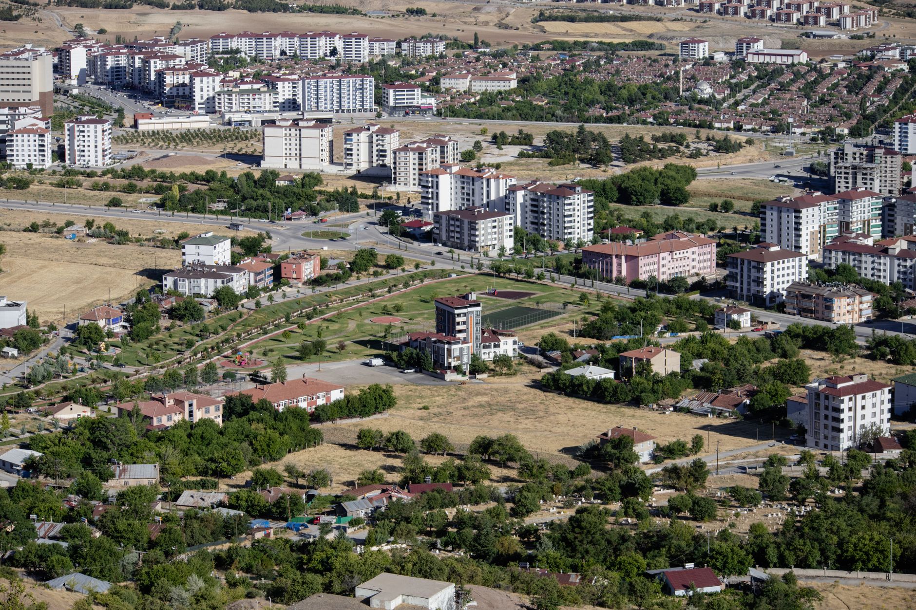 Aerial cityscape of Elâzığ, Türkiye showcasing apartments and greenery in summer. — Experience the Thrill: Watching F1 Races