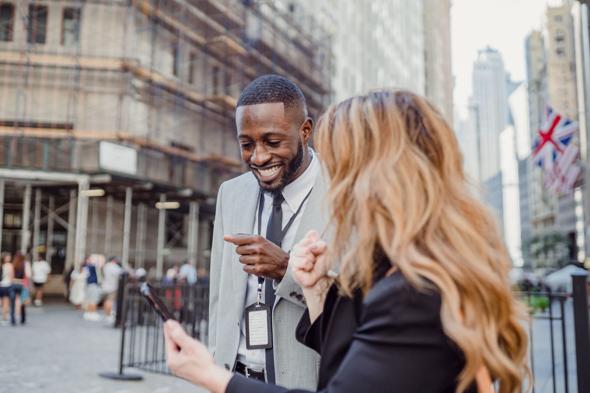 Two business professionals engage in lively conversation on an urban street, sharing insights. — How White Label SEO Can Help